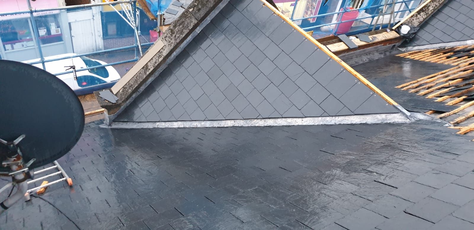 During - New slate roofing and leadwork being installed with battens still exposed on the remaining roof section