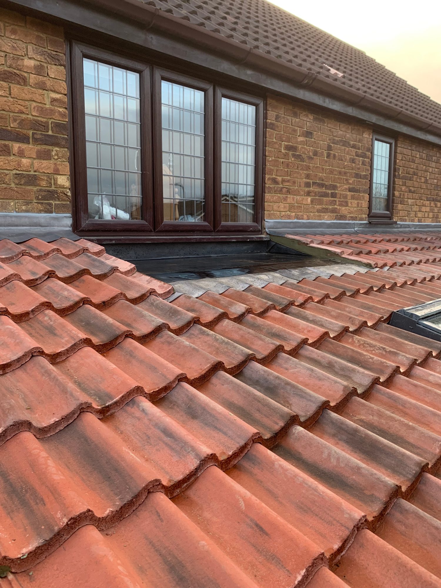 Completed - The completed tiled roof showing the finished leadwork around the upper-level windows