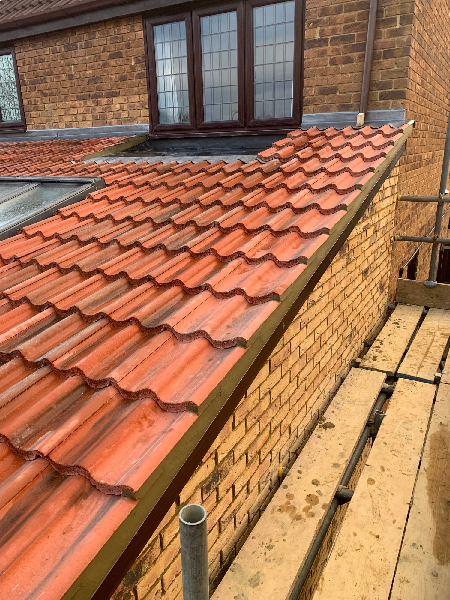 Completed - The completed tiled roof showing the finished leadwork beneath the upper-level windows