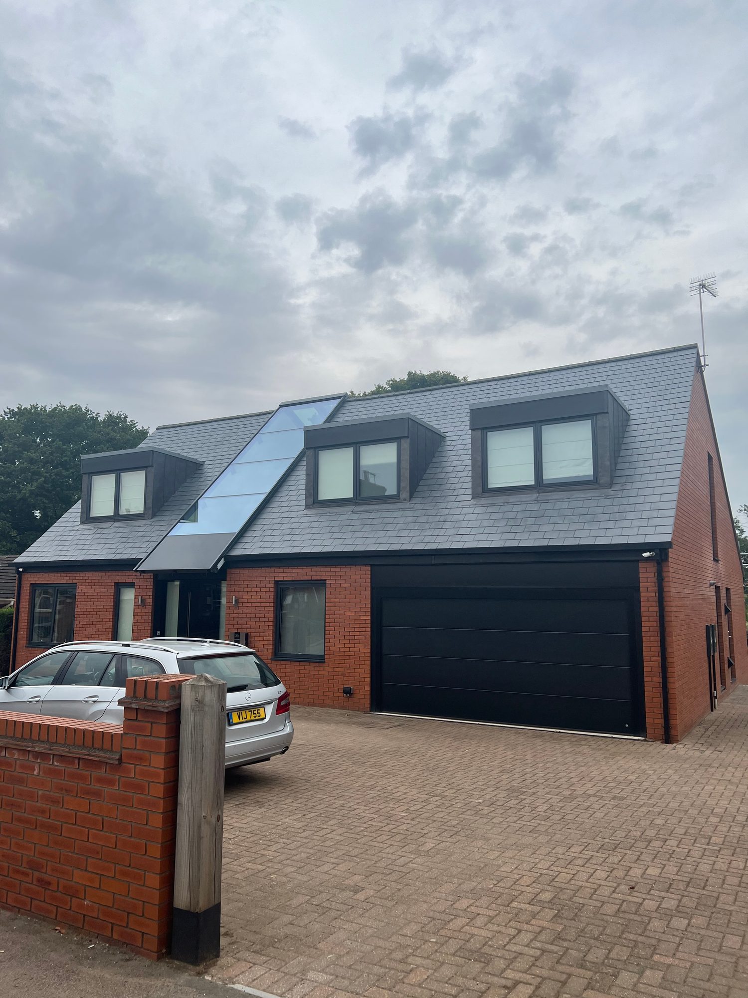 Completed - Completed slate roof with three dormer windows and the central glazed roof feature