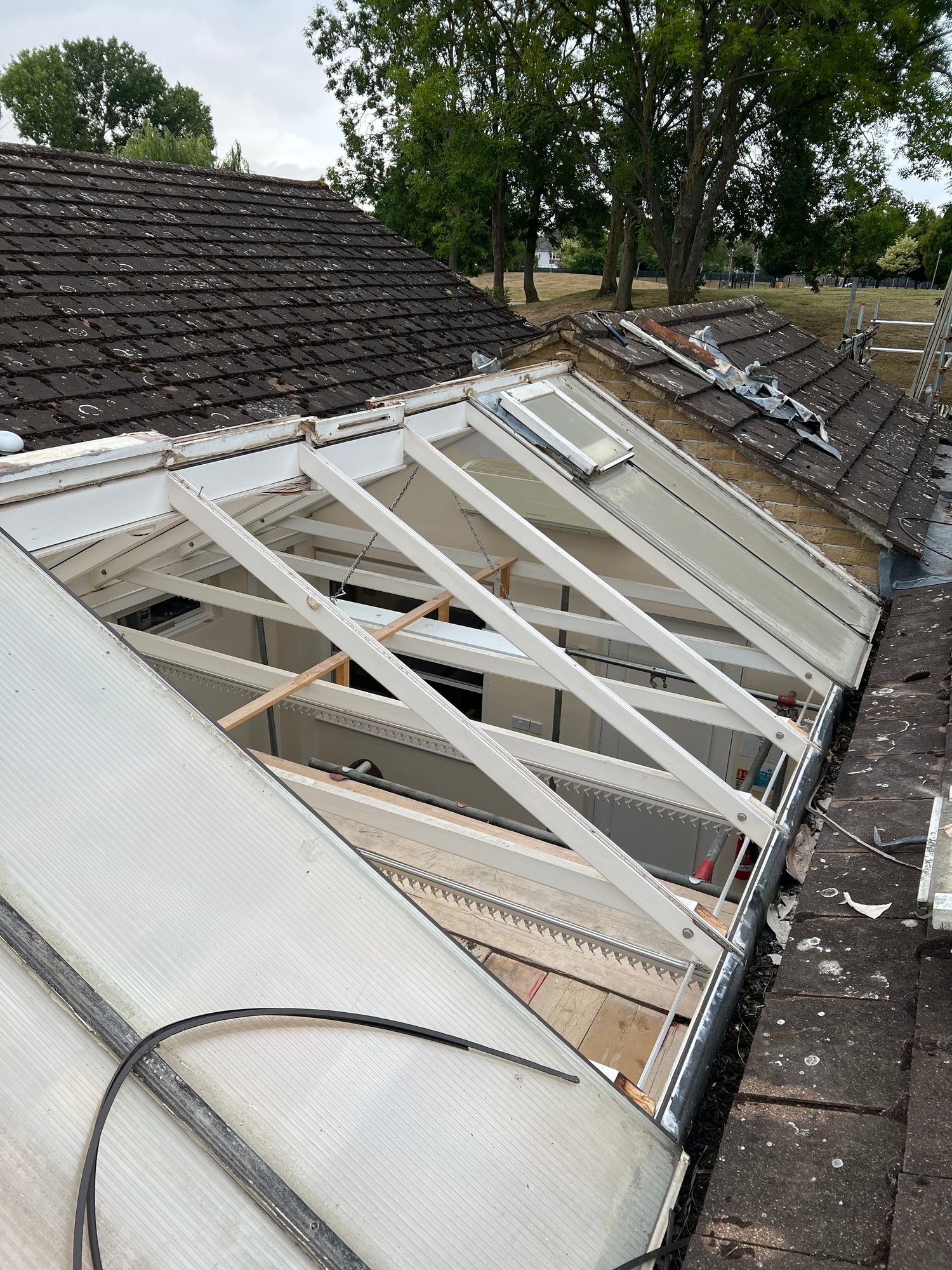 During - The existing conservatory roof panels being removed to expose the roof structure ready for replacement