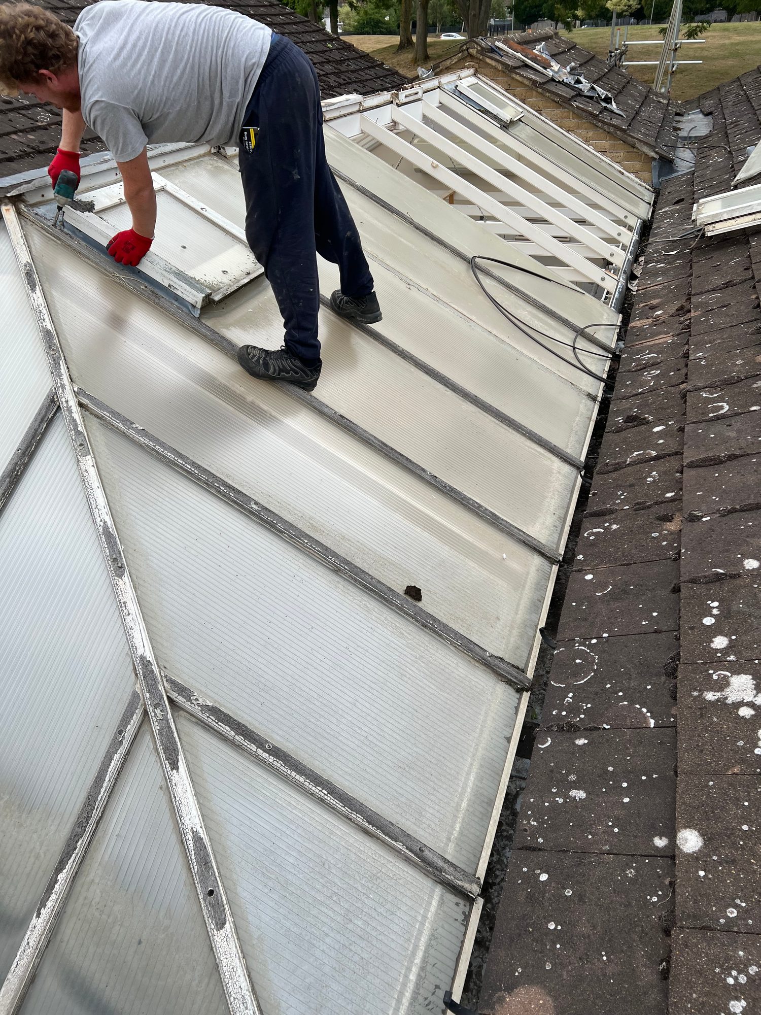 Before - The existing conservatory roof panels being removed during the roof replacement works