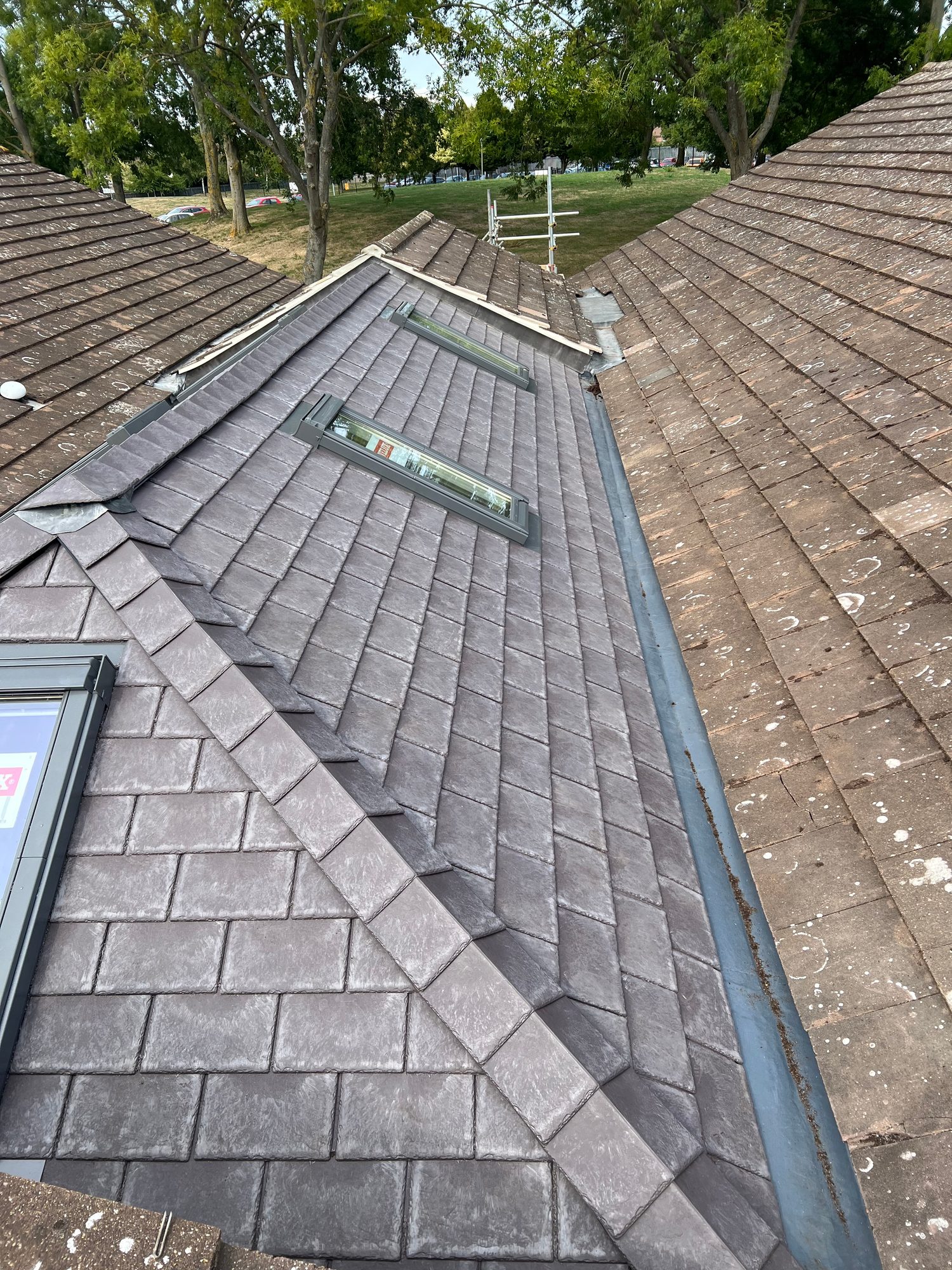 Completed - The completed tiled conservatory roof with new grey tiles, roof windows and surrounding leadwork