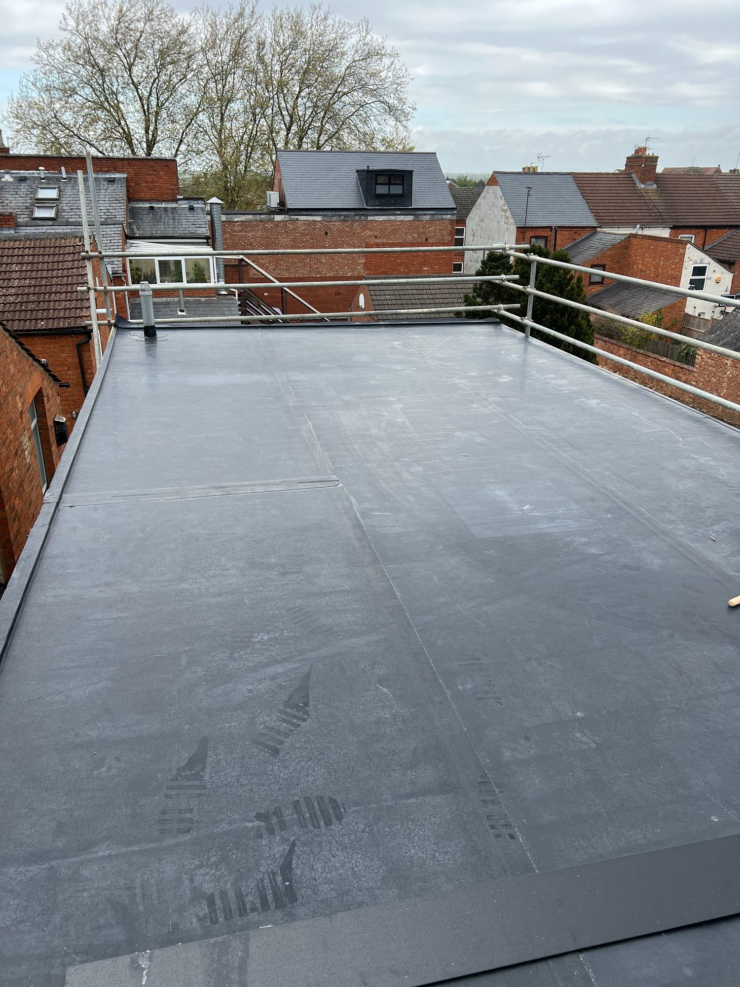 Completed - The completed flat roof with the new roofing membrane fully installed and finished around the roof edges