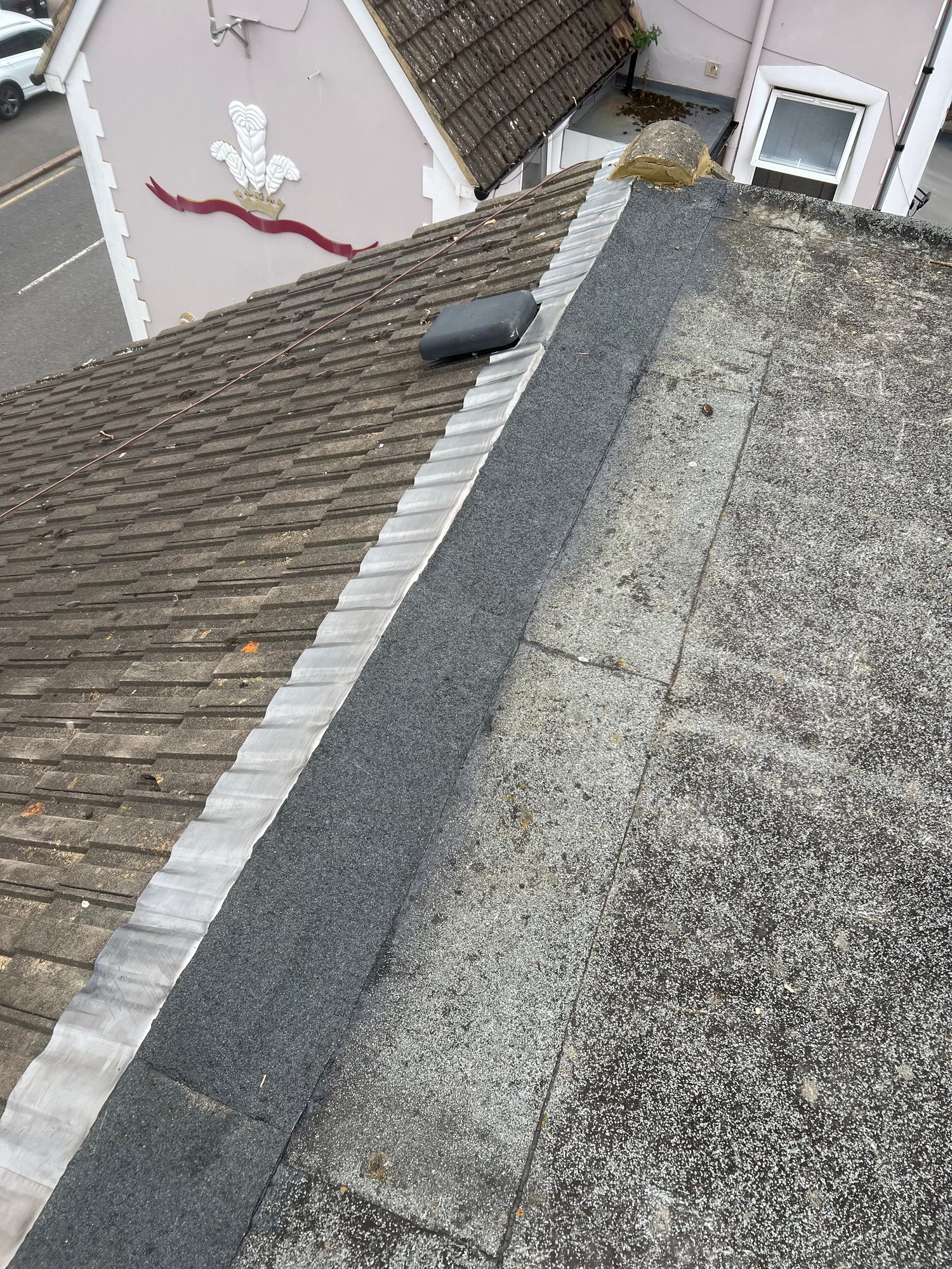 Completed - The completed roof junction showing new lead flashing between the flat roof and tiled pitched roof