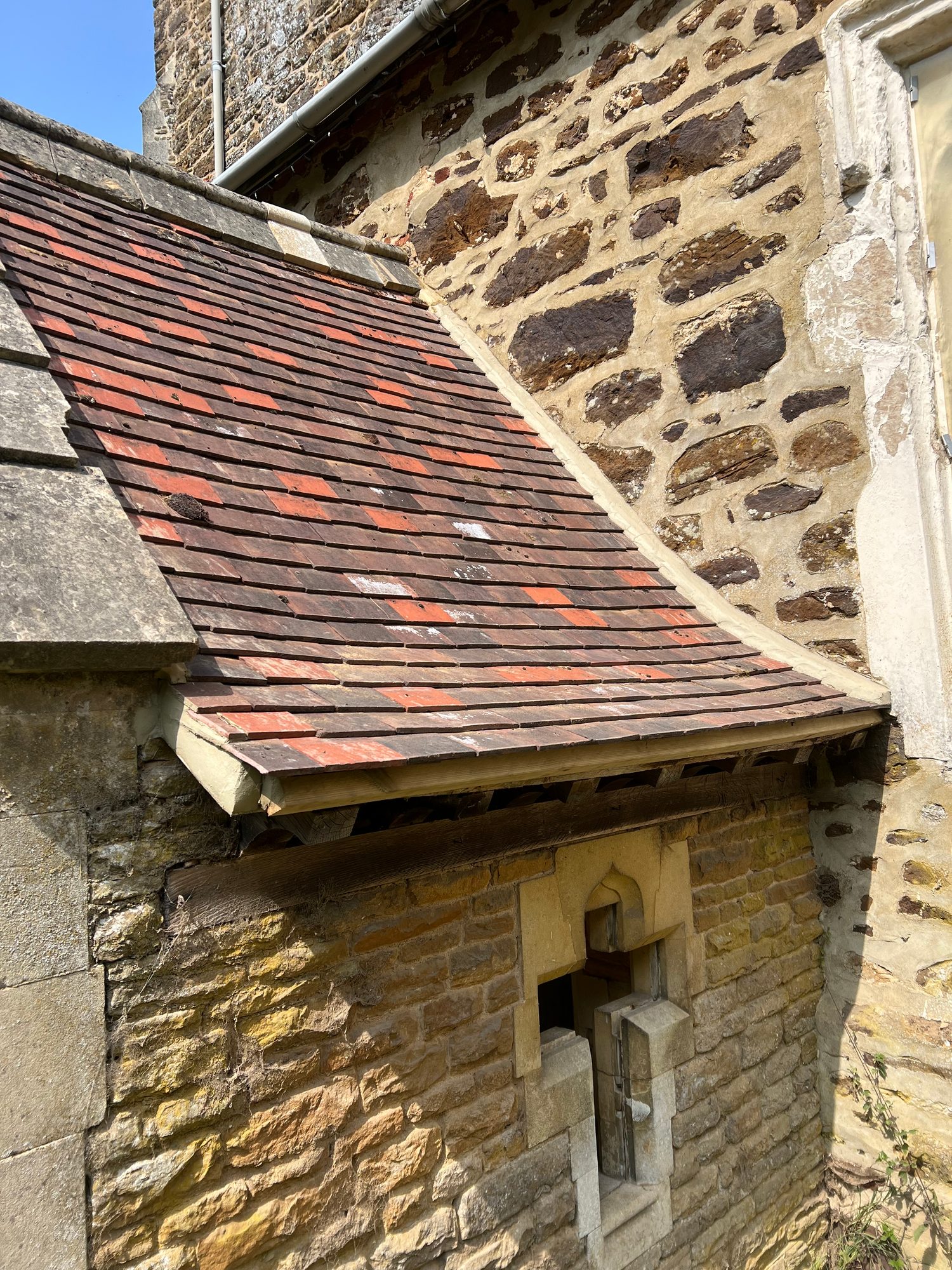 Completed - The completed tiled roof section with restored stonework, timber detailing and guttering on the property