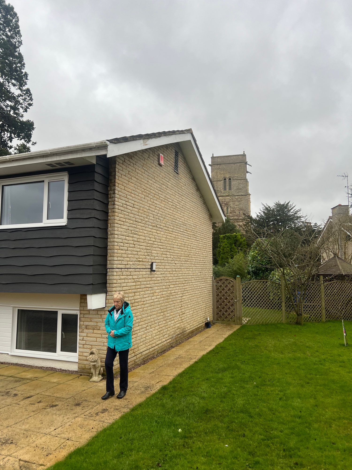 Before - The completed exterior of the property showing the brickwork, cladding, windows, paving, lawn and garden fencing