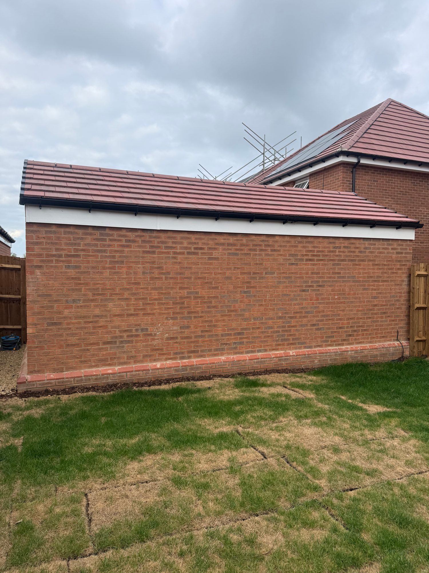 Original side elevation of the brick garage before the window and doorway openings were formed