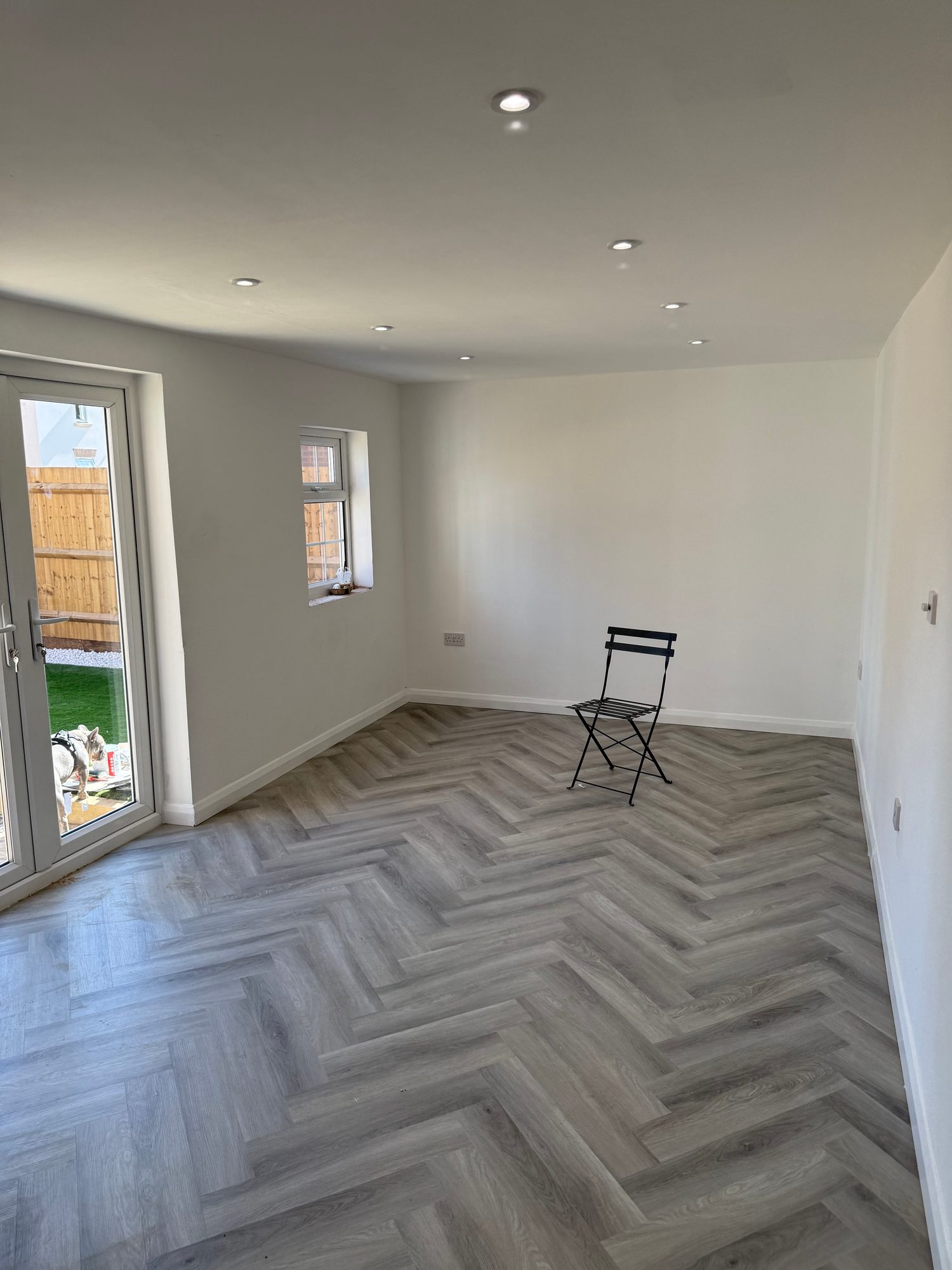 Completed interior showing the fitted window, glazed garden doors and herringbone flooring