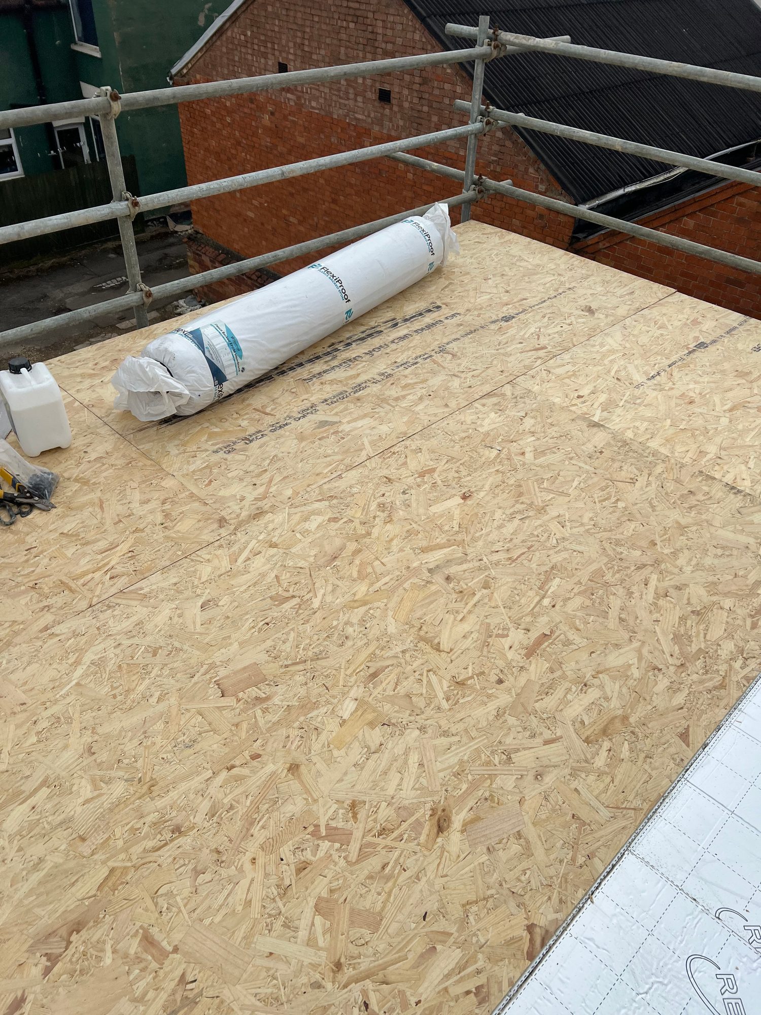 During - The new OSB roof deck installed with roofing membrane ready to be fitted