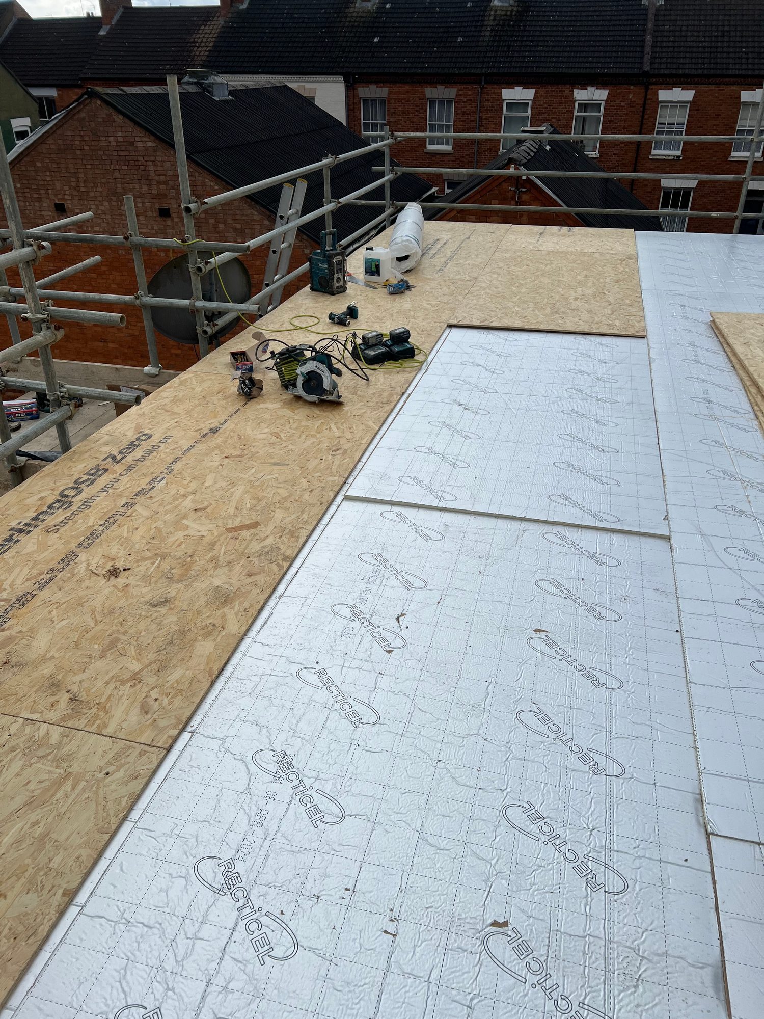 During - The flat roof during installation with insulation boards and timber decking being fitted